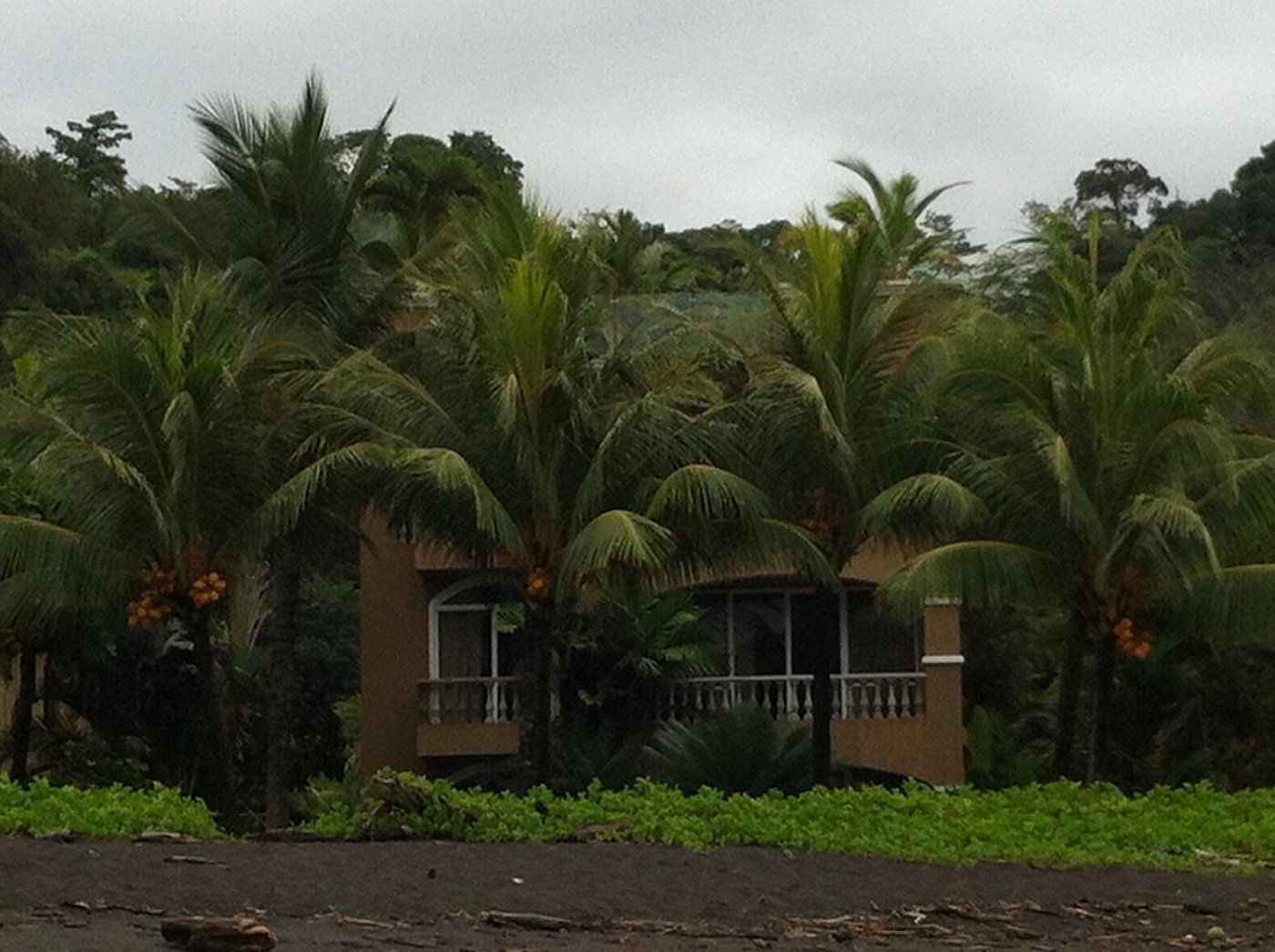 The condo building seen from the black-sand beach